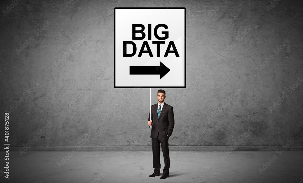 business person holding a traffic sign with BIG DATA inscription, new idea concept business person holding a traffic sign with BIG DATA inscription, new idea concept