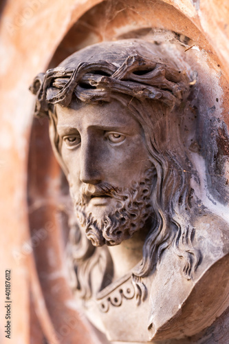 Historic Jesus on the winter mystery old Prague Cemetery, Czech Republic