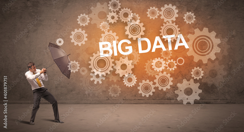 Businessman defending with umbrella from BIG DATA inscription, technology concept Businessman defending with umbrella from BIG DATA inscription, technology concept