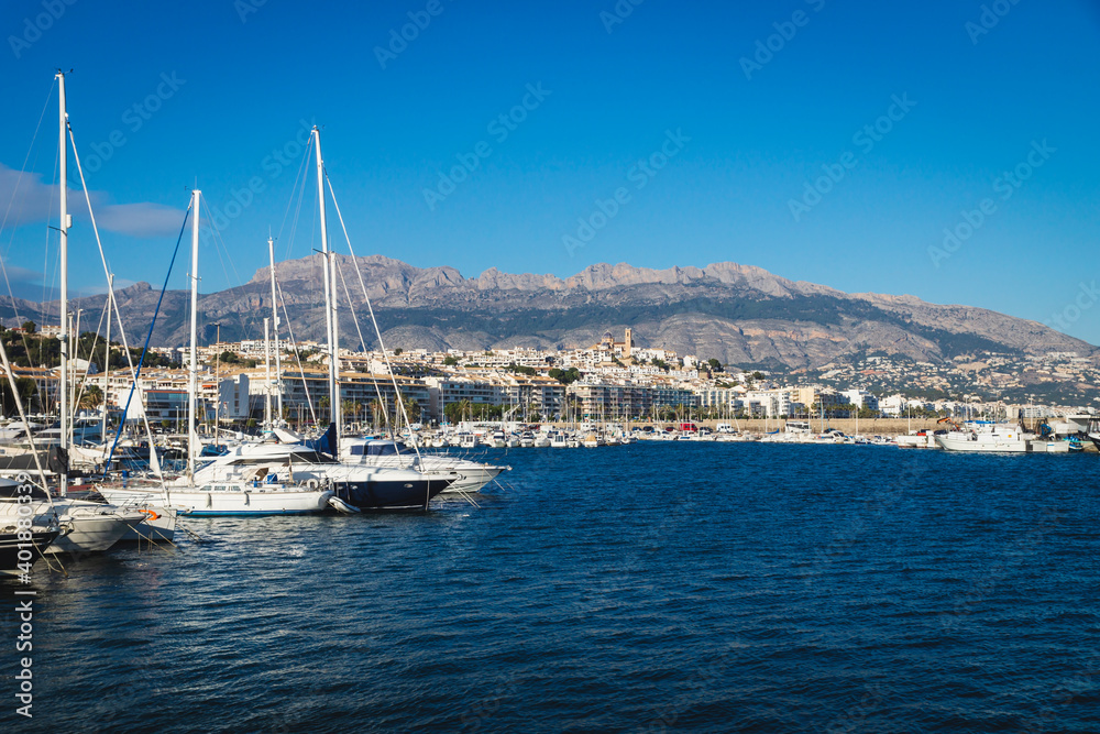 Boats at the port of Altea with view on mountain range with old city and cathedral, Altea, Costa Blanca, Spain
