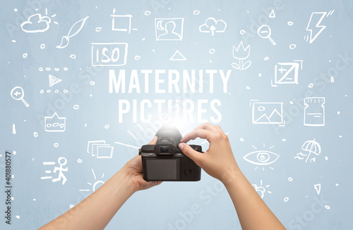 Hand taking picture with digital camera and MATERNITY PICTURES inscription, camera settings concept