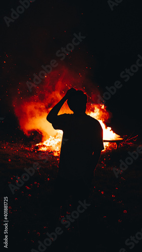 silhouette of a man with a bonfire
