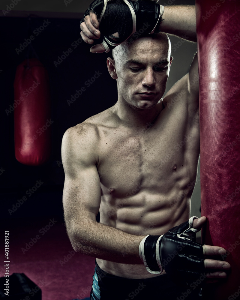 Mixed Martial Arts Fighter in the Gym wearing boxing Gloves Mixed Martial Arts Fighter in the Gym wearing boxing Gloves