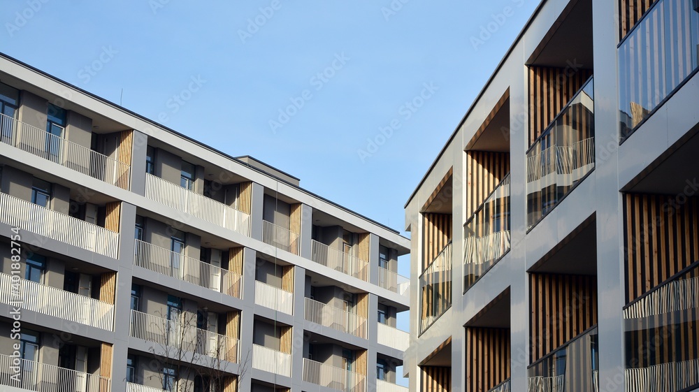 Facade of new apartment building. Glass balcony and clean look of modern architecture building with blue sky background. Facade of new apartment building. Glass balcony and clean look of modern architecture building with blue sky background.