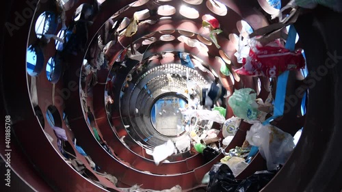 Sorting of garbage by means of rotation in the special device for separation of plastic waste. Disposal of trash products in industry. Recycling plastic packs.