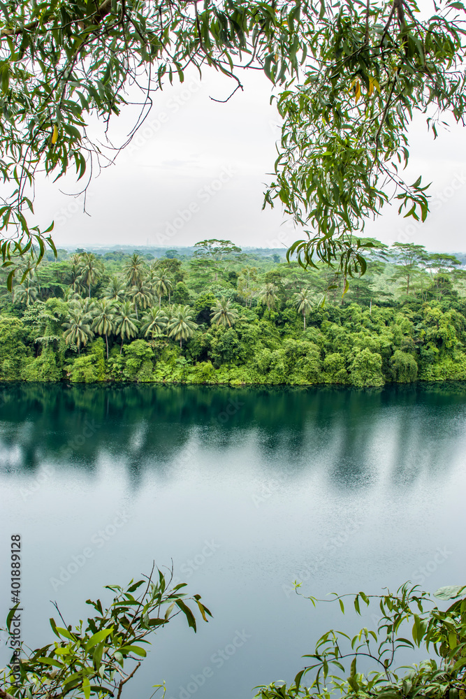 The view of Ubin Quarry lake and rainforest from Puaka’s Hill. It is  located in the western part of pulau ubin island Singapore. 
The background is Malaysia. 