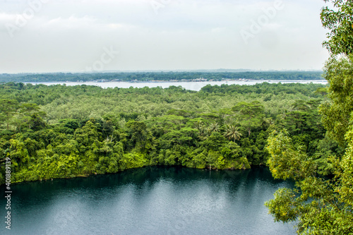 The view of Ubin Quarry lake and rainforest from Puaka’s Hill. It is  located in the western part of pulau ubin island Singapore.  The background is Malaysia.  © Danny Ye