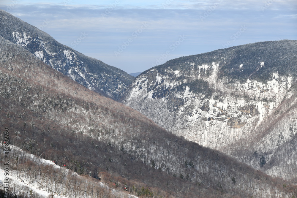Stowe Ski Resort in Vermont, view to the the Smugglers Notch pass, December fresh snow on trees early season in VT, panoramic hi-resolution image