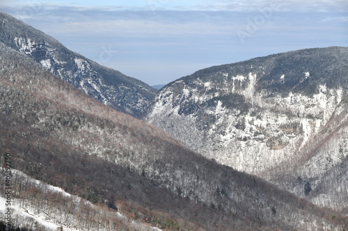 Stowe Ski Resort in Vermont, view to the the Smugglers Notch pass, December fresh snow on trees early season in VT, panoramic hi-resolution image