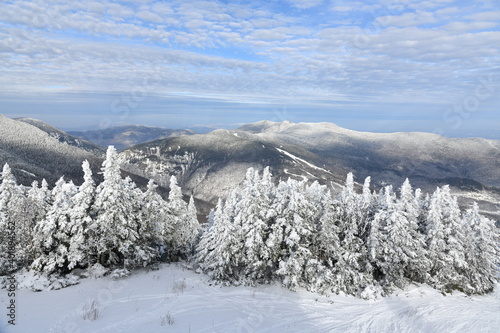 Stowe Ski Resort in Vermont, view to the Mansfield mountain slopes, December fresh snow on trees early season in VT, panoramic hi-resolution image