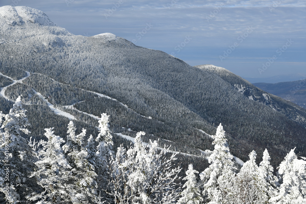 Stowe Ski Resort in Vermont, view to the Mansfield mountain slopes, December fresh snow on trees early season in VT, panoramic hi-resolution image Stowe Ski Resort in Vermont, view to the Mansfield mountain slopes, December fresh snow on trees early season in VT, panoramic hi-resolution image