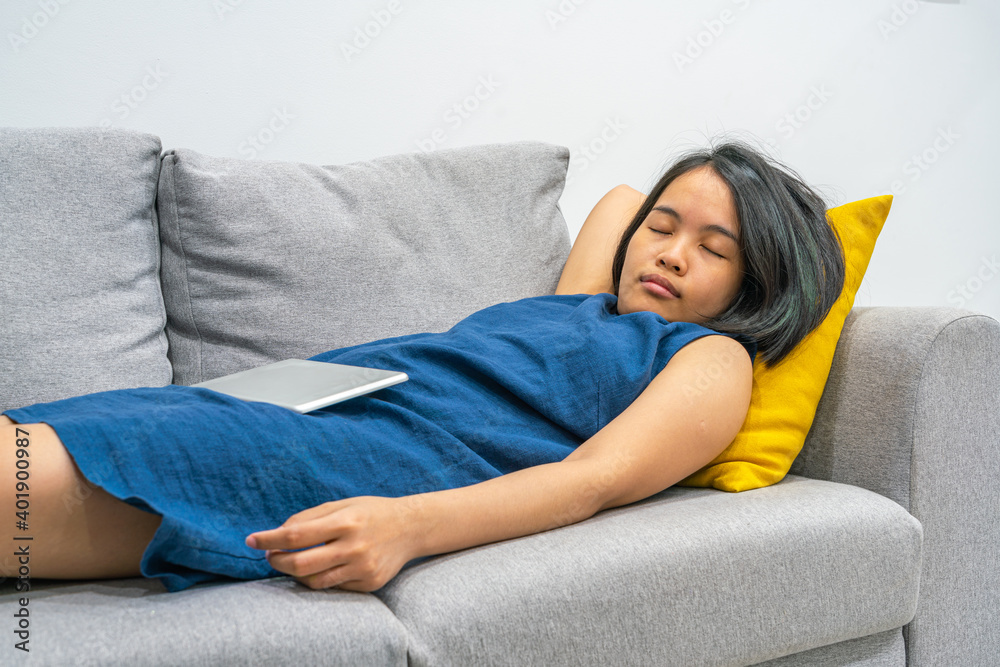 Young Asian woman stay home and sleep on the sofa