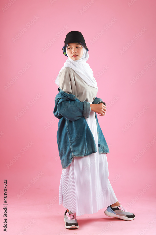 Fashion portrait of young beautiful asian muslim woman with wearing hijab isolated on pink background. Fashion portrait of young beautiful asian muslim woman with wearing hijab isolated on pink background.