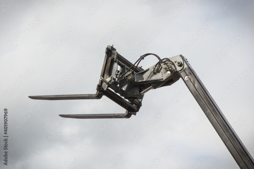 Part of forklift loader or stacker on sky background. Technology in transport Part of forklift loader or stacker on sky background. Technology in transport