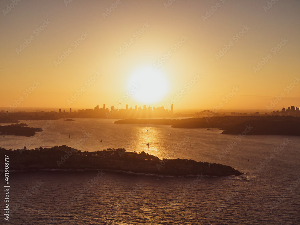 Panoramic sunset aerial drone view of famous Sydney Harbour with the CBD city centre skyline in the background. South Head, a headland to the north of Watsons Bay suburb, in the foreground. Panoramic sunset aerial drone view of famous Sydney Harbour with the CBD city centre skyline in the background. South Head, a headland to the north of Watsons Bay suburb, in the foreground.