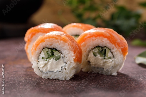 Philadelphia roll sushi on textured background still life. Restaurant concept. Close-up.