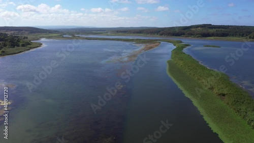 Wallpaper Mural A panoramic shot from Durugol Turkey. There is a lake near a path filled with forest and green grass under the blue sky. Torontodigital.ca