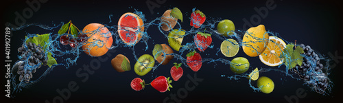 Fototapeta Naklejka Na Ścianę i Meble -  Panorama with fruits in water - juicy grapes, cherries, grapefruit, kiwi, strawberries, lime, lemon strengthen the body and increase the immunity of people