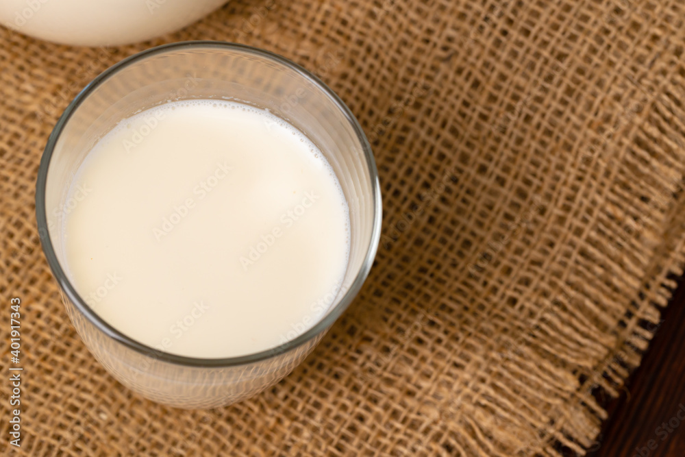 Glass cup of milk on table close up Glass cup of milk on table close up
