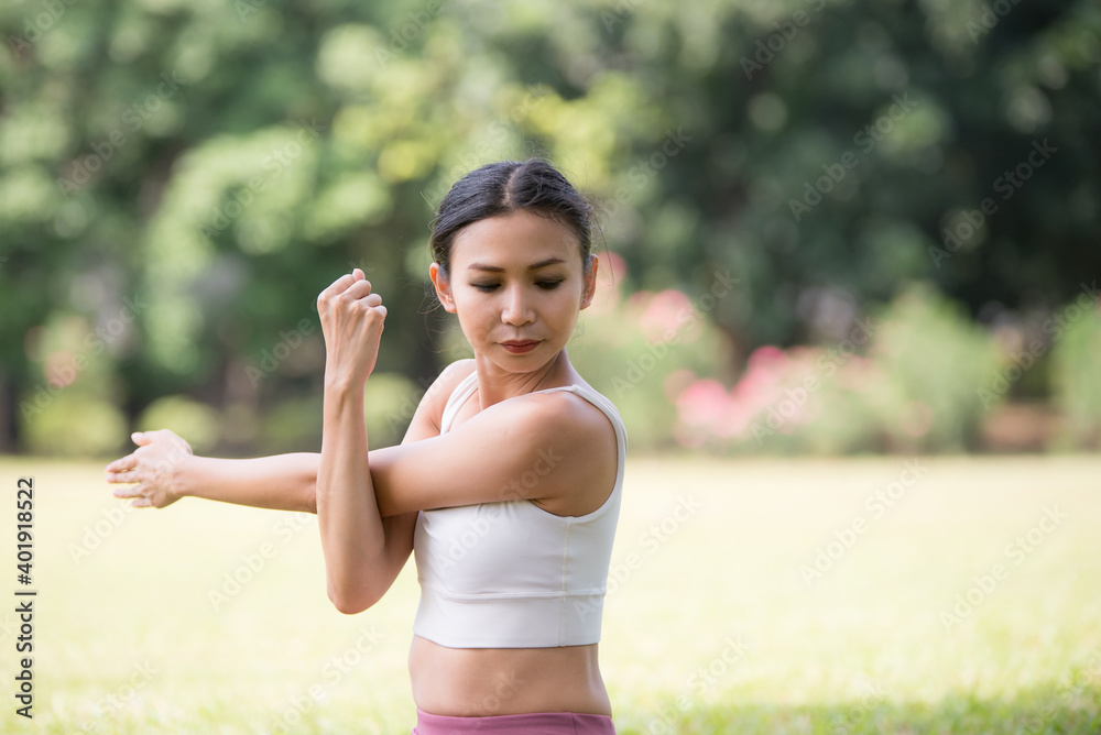 Asian model poses yoga in a park on a natural green background, health care concept, beautiful body structure, fit body Asian model poses yoga in a park on a natural green background, health care concept, beautiful body structure, fit body