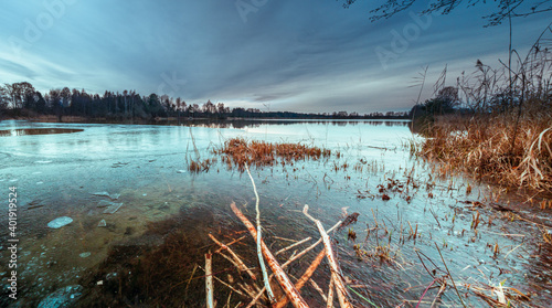 Ice Cold Winter Bavarian lake with warm sunset sky background photo