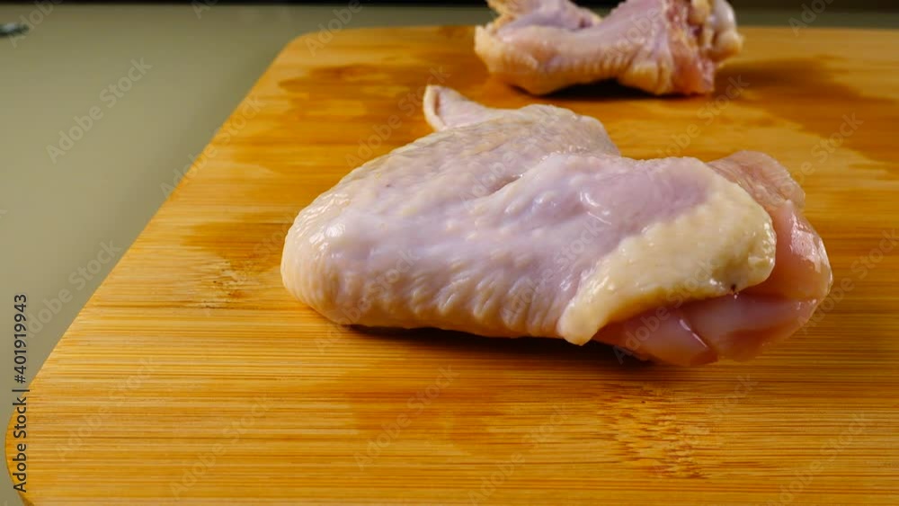 Fresh chicken wings on a cutting board. Fresh chicken wings on a cutting board.