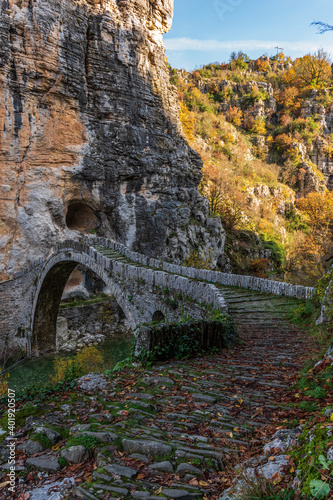 Kokori's old arch stone bridge (Noutsos) during fall season  situated on the river of Voidomatis in  Zagori, Epirus Greece. photo