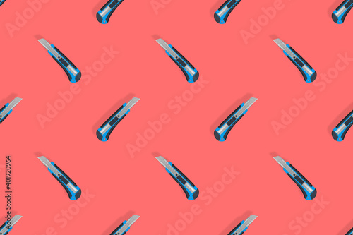 Stationery knives seamless pattern on a red background.