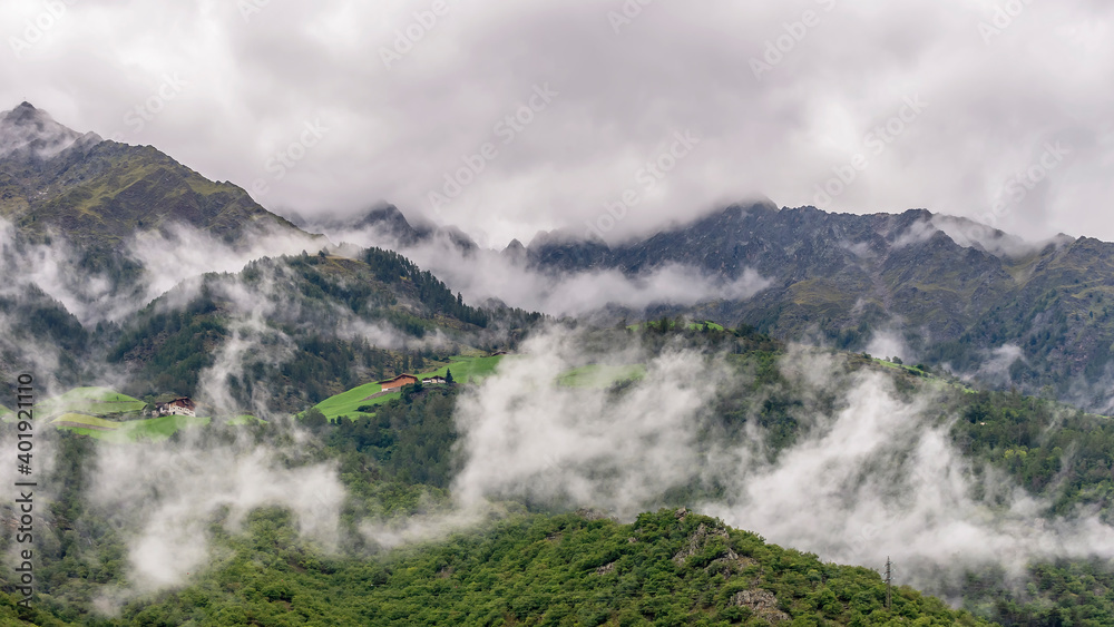 The Alps above Naturno, South Tyrol, Italy, partially covered by layers of low white clouds The Alps above Naturno, South Tyrol, Italy, partially covered by layers of low white clouds