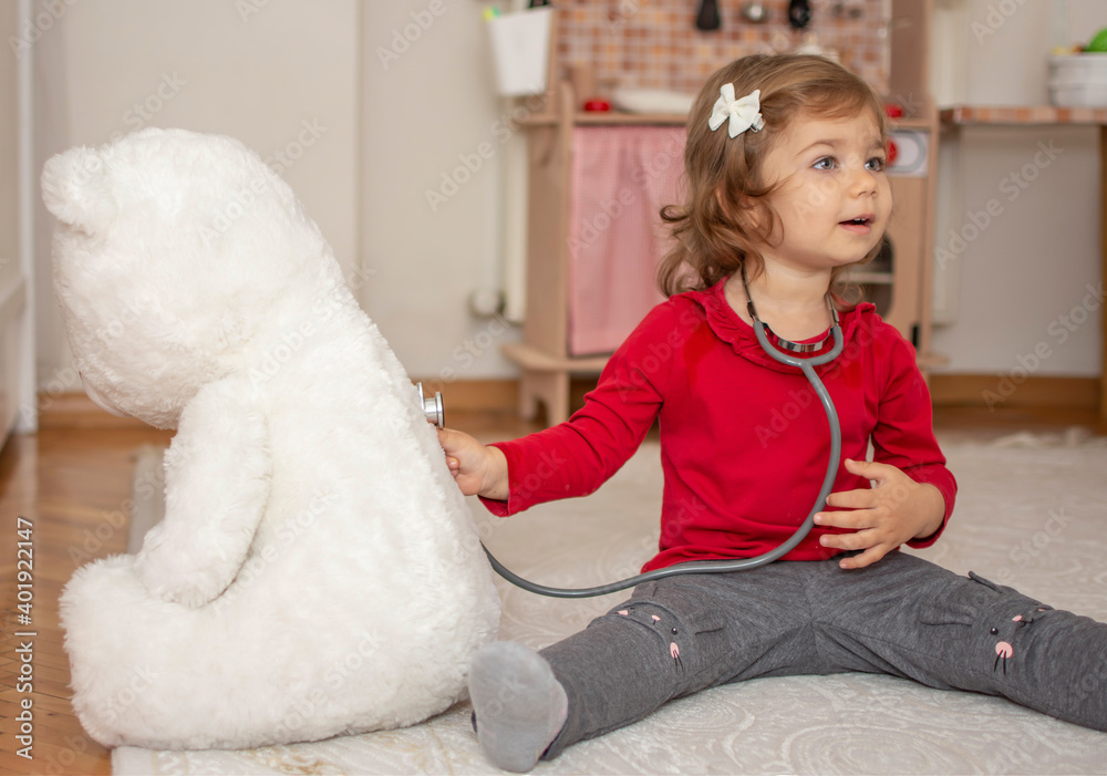 Portrait of cute adorable baby girl playing doctor or nurse with stethoscope at home or kindergarten. Funny child and role playing. Portrait of cute adorable baby girl playing doctor or nurse with stethoscope at home or kindergarten. Funny child and role playing.