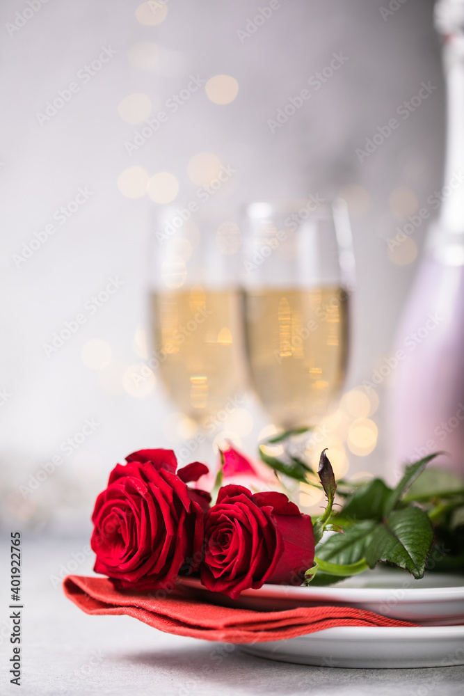 Valentines day table setting red roses and champagne glasses on concrete background. Valentine 's greeting card - Image Valentines day table setting red roses and champagne glasses on concrete background. Valentine 's greeting card - Image