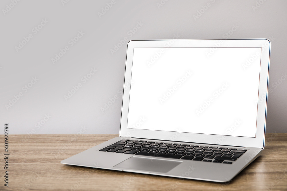 Modern laptop on table in office Modern laptop on table in office