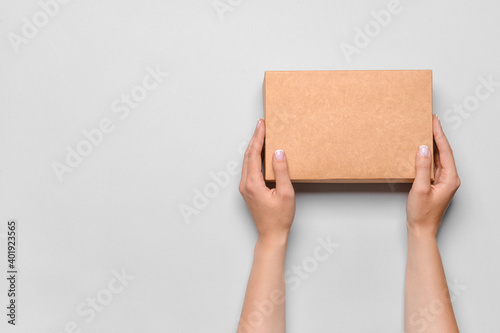 Hands with cardboard box on white background © Pixel-Shot