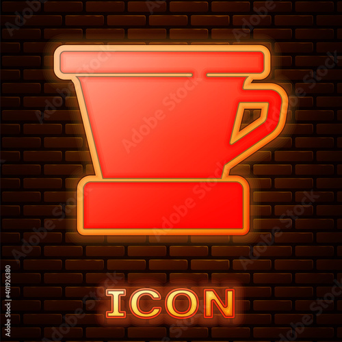 Glowing neon V60 coffee maker icon isolated on brick wall background. Vector.