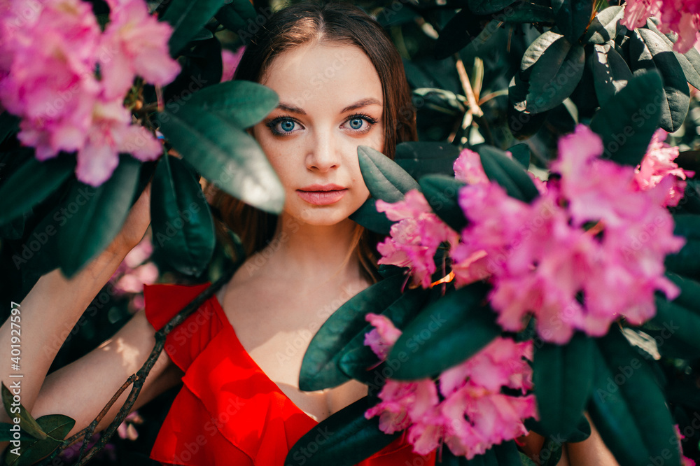 Young beautiful girl posing among the flowering tree Young beautiful girl posing among the flowering tree