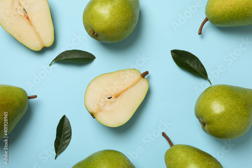 Fresh green pears on blue background, top view