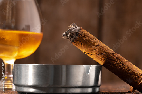 Glass of whisky and lighted cigar in an ash tray © fotofabrika