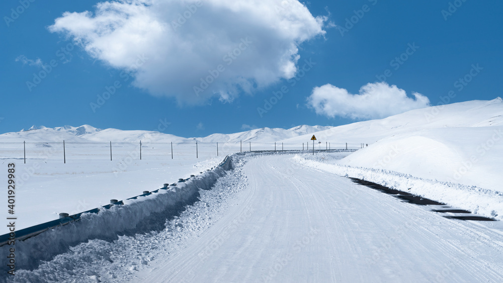 Road with snow, blue sky and white clouds in Tibet,West of China. Road with snow, blue sky and white clouds in Tibet,West of China.
