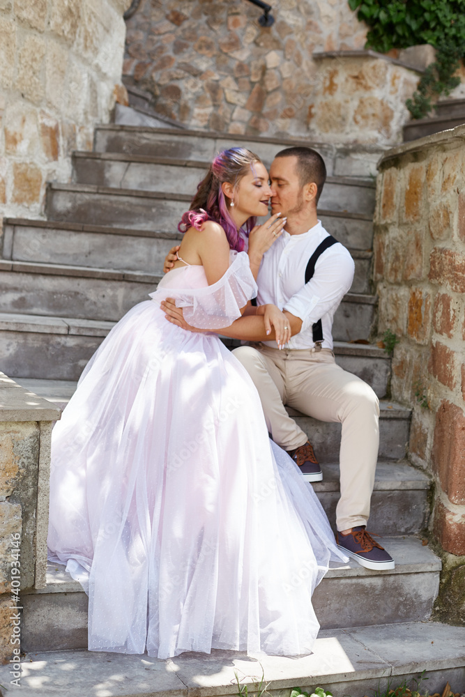 Man and a woman walk and hug. Couple in love, bride and groom