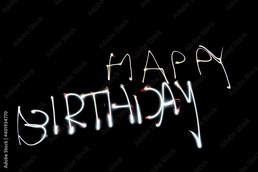 light painting saying happy birthday, bright light on black background light painting saying happy birthday, bright light on black background