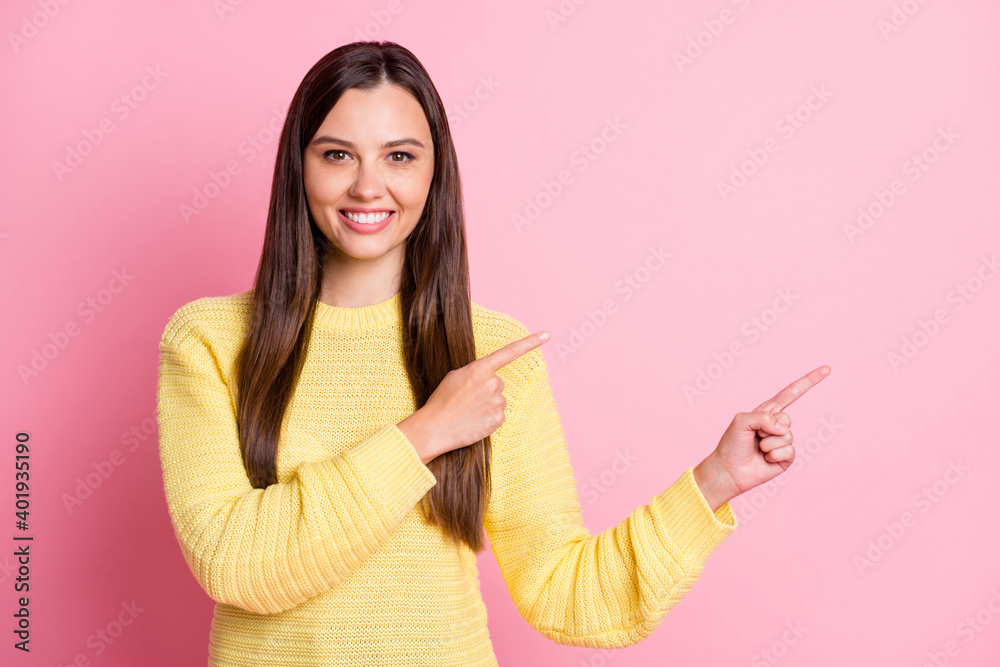 Photo of young beautiful beaming smiling positive good mood girl pointing fingers in copyspace isolated on pink color background Photo of young beautiful beaming smiling positive good mood girl pointing fingers in copyspace isolated on pink color background