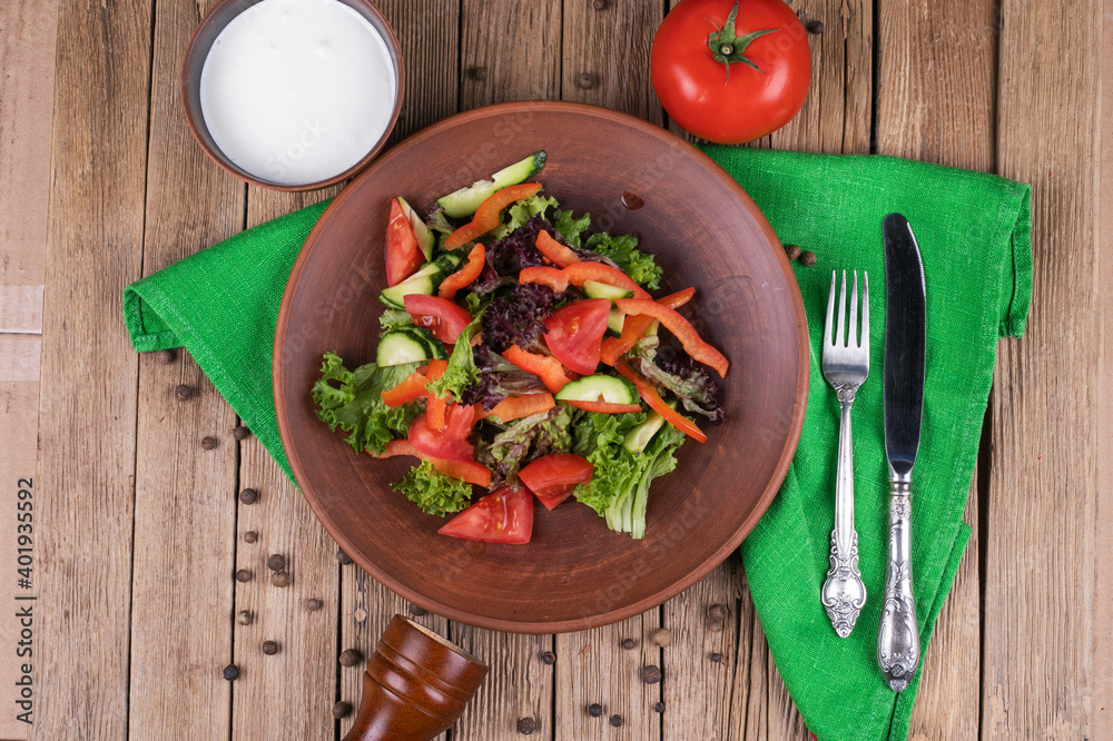 Salad from fresh vegetables in ceramic bowl Salad from fresh vegetables in ceramic bowl