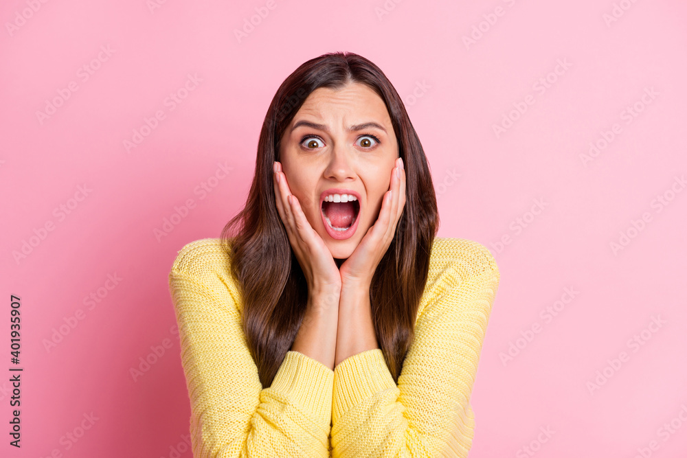 Portrait of young attractive scared afraid shocked terrified girl hold hands on cheeks isolated on pink color background Portrait of young attractive scared afraid shocked terrified girl hold hands on cheeks isolated on pink color background