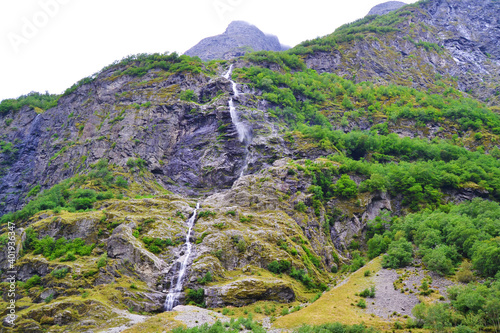 The mountain and the waterfall. Beautiful scenic view. Summer in Norway, Naeroyfjord. photo