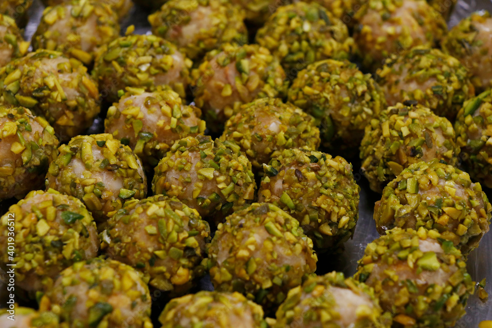 Fototapeta premium pistachio rolled vanilla flavored energy balls in close up