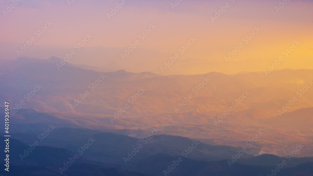 Landscape wide view sunrise or sunset of  of mountains in misty day.