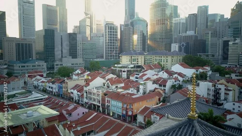 Drone footage of old buildings against tall skyscrapers in the city Singapore