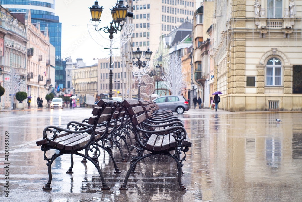 Rain in town - rain drops and reflection in historic center of Novi Sad, Serbia