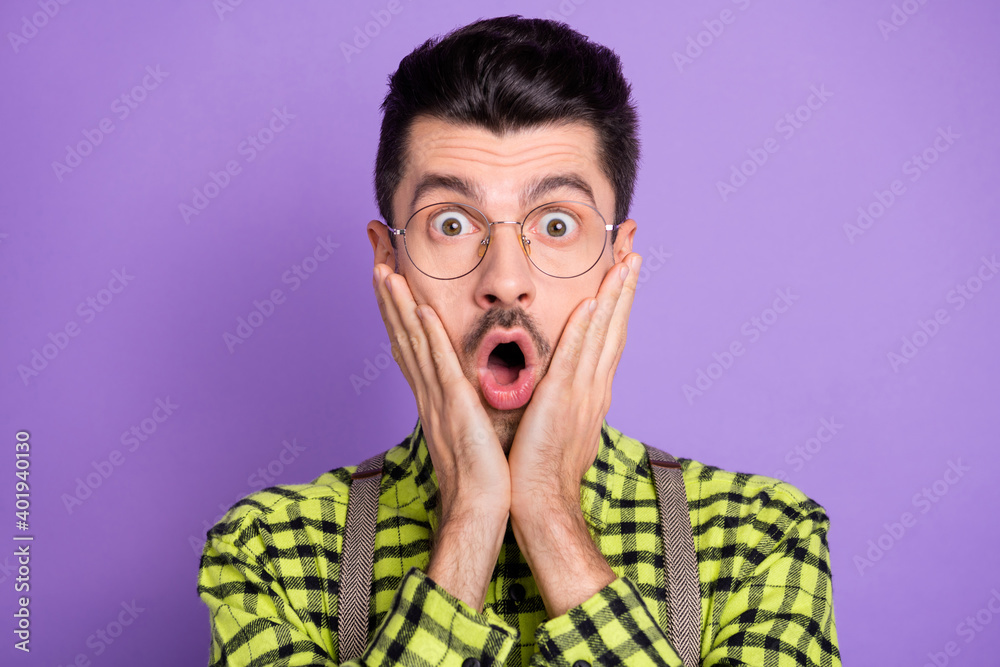 Photo portrait of impressed guy touching face cheeks isolated on vivid violet colored background Photo portrait of impressed guy touching face cheeks isolated on vivid violet colored background