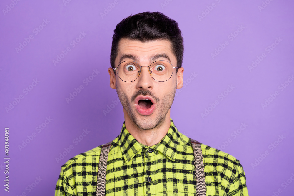 Photo portrait of amazed man with open mouth isolated on vivid violet colored background Photo portrait of amazed man with open mouth isolated on vivid violet colored background